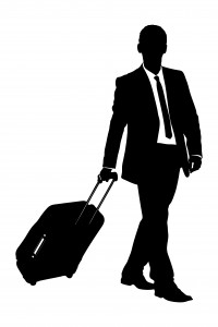A silhouette of a business traveler carrying a suitcase
